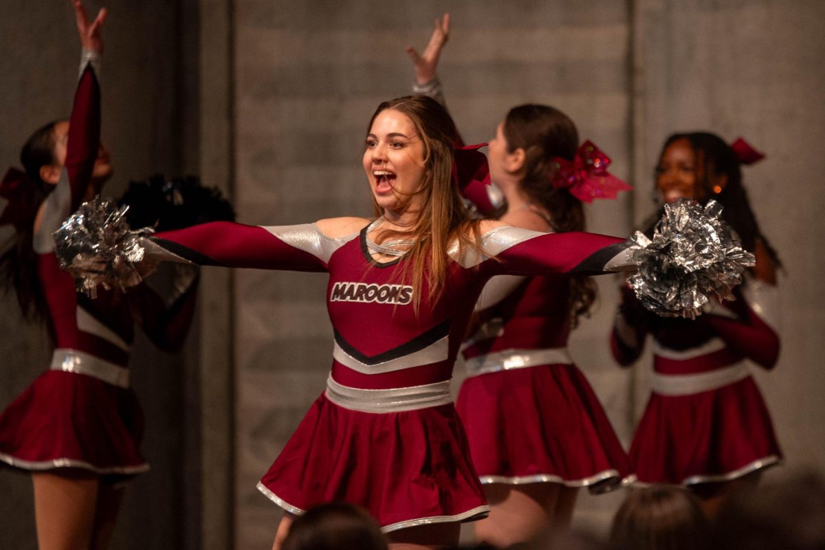 STAGE PRESENCE. During the ArtsFest opening assembly, senior Ceci Siegel sports a warm smile while performing with the rest of the dance team. This routine helped kick off ArtsFest. 