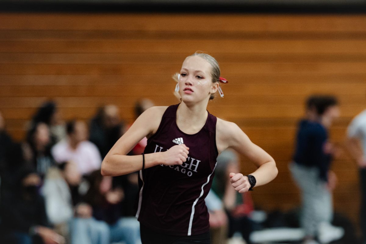 Sprinting through Henry Crown Field House, Junior Celia Lukas competes at the Midway Miles One on Feb. 6.