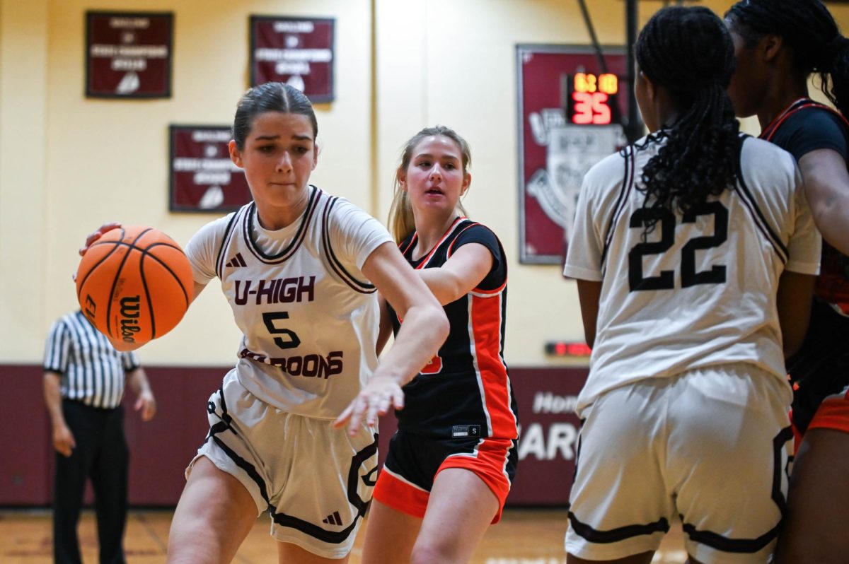 Junior Venice Lichstein drives the basketball as Junior Nanak Ofori-Mante sets a screen during a girls' varsity basketball game on Jan. 13 against Lake Forest Academy.