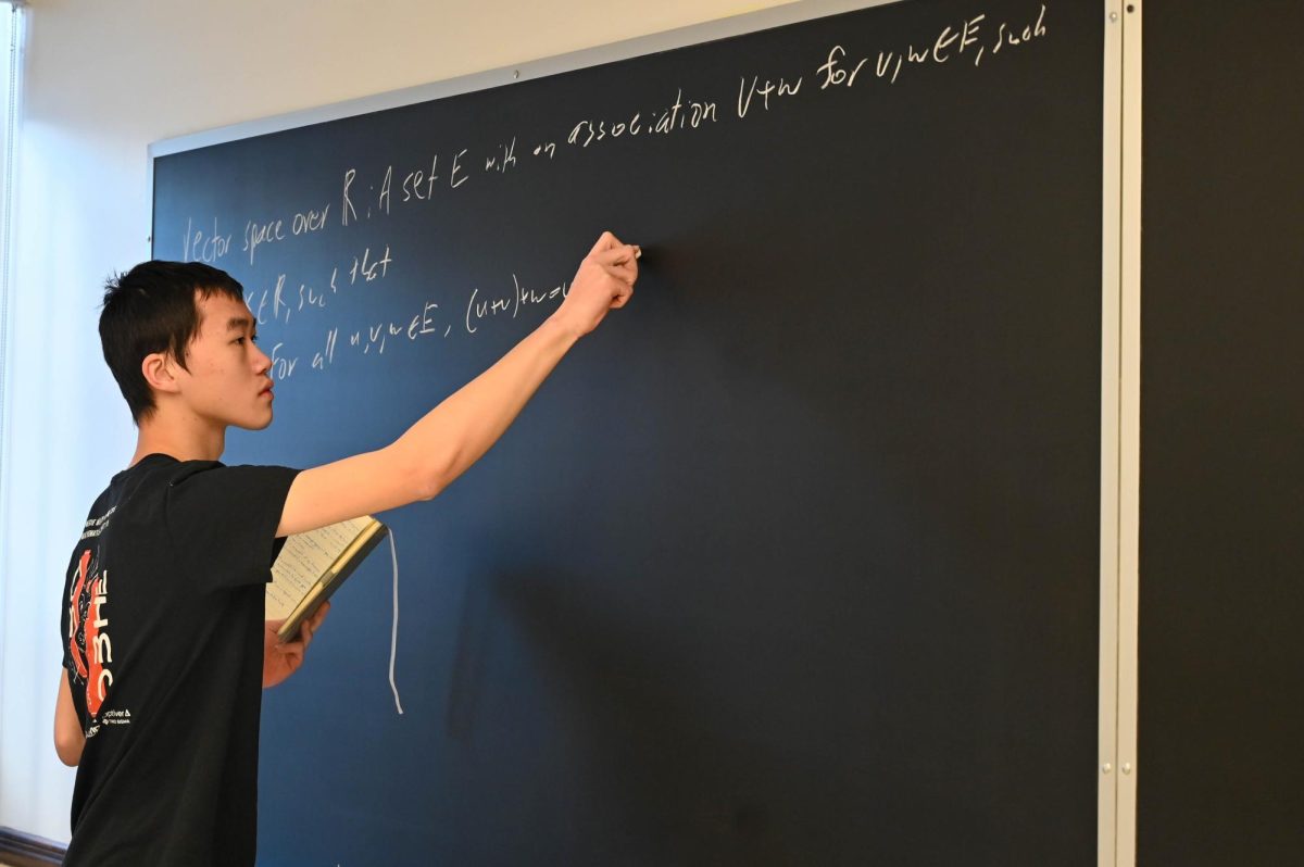 Senior Victor Chen works on an equation in a math classroom. Whether by solving an elegant proof, developing a biological algorithm or taking on a grid puzzle, math has been an invariant part of Victor’s life for seven years, and it shows no signs of ending.
