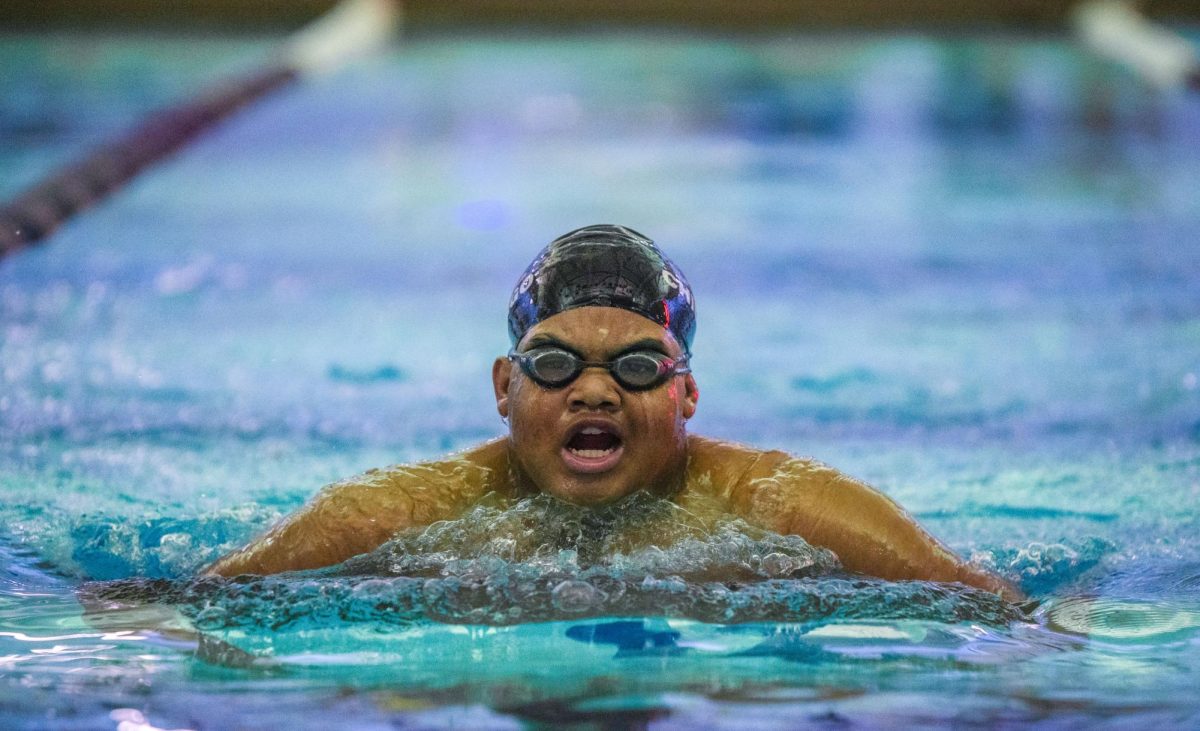 Swimming breast stroke, junior Gabe Lockhart swims at a home meet on Jan. 28.
