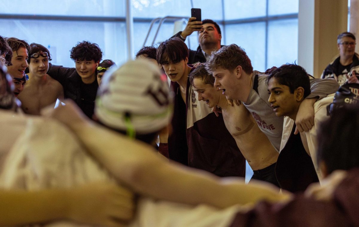 The swim team holds a huddle during the Jan. 28 quad meet at Ratner.
