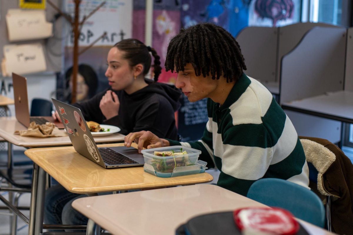 Senior Jonah Austen concentrates during a mock trial practice alongside teammate Samara Grossman. The team recently finished their season at the state competition without advancing to nationals. 