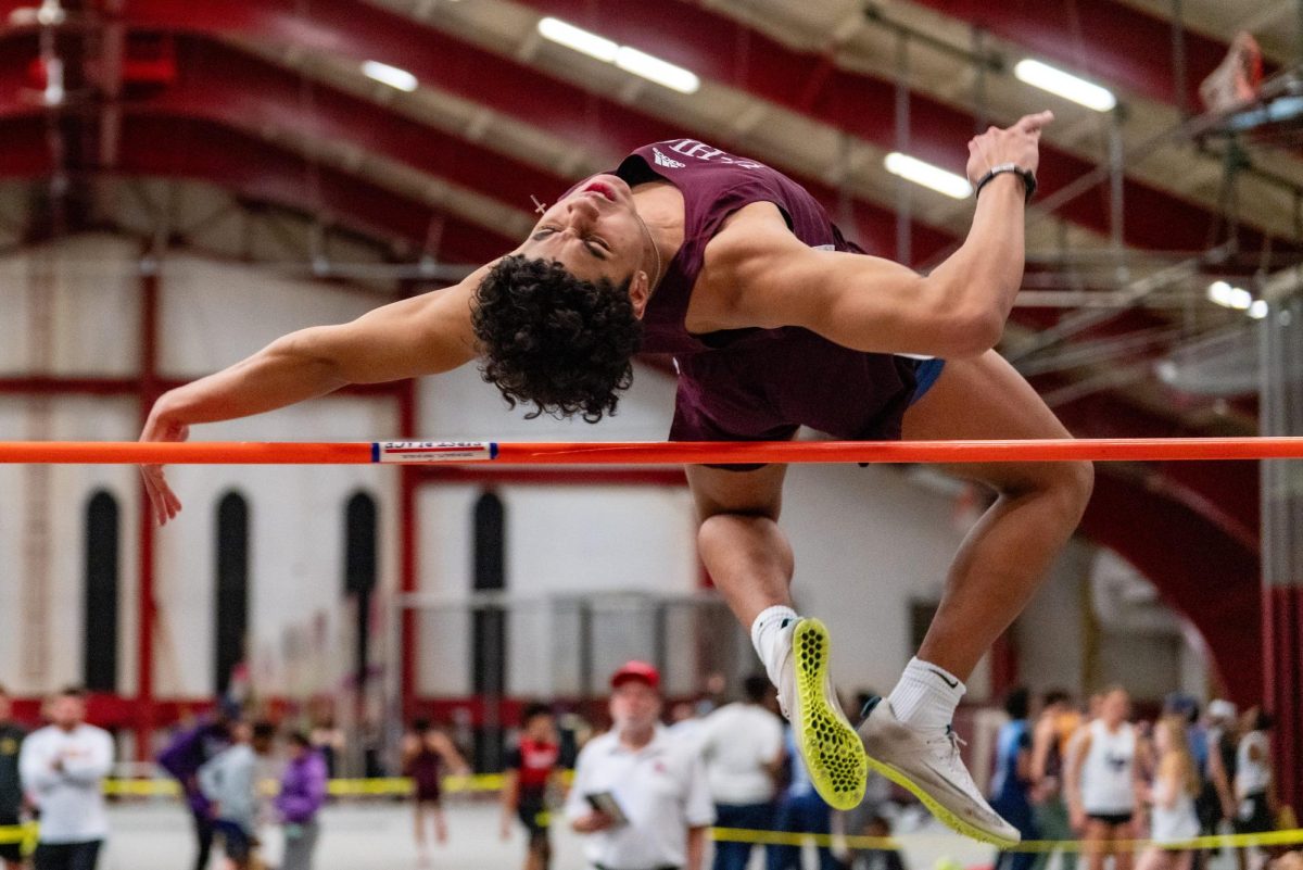  SOARING IN THE AIR. Senior Ty Quiles jumps over the high jump crossbar on Feb. 6 at Henry Crown Field House during a track meet.
