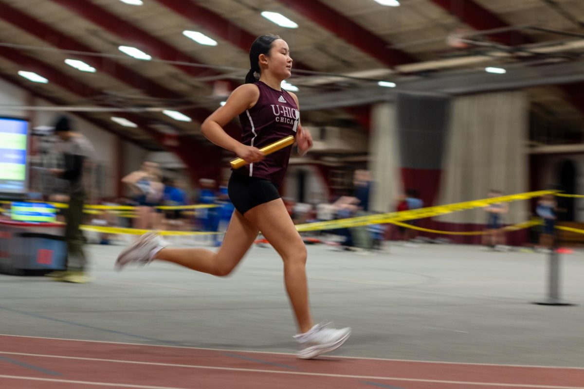 SPEEDY SPRINTS. Junior Suna Choi-Hortatsu races in a relay for U-High’s indoor track team at Henry Crown Field House on Feb. 6.