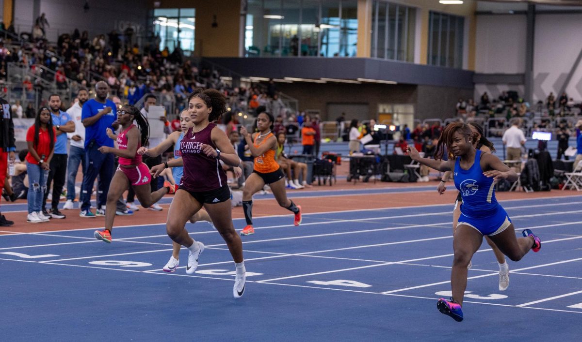 DYSON DASH. With the wind in her hair, senior Eve Dyson runs at Conrad Worrill Track and Field Center at Gately on Feb. 14. Eve won first place in the qualifying race.