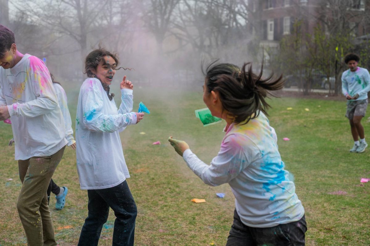 Seniors Satya Dominguez-Hultgren and Sara Park throw colored powder at each other at Scammon Garden. The annual Holi event this year was held on April 3. 