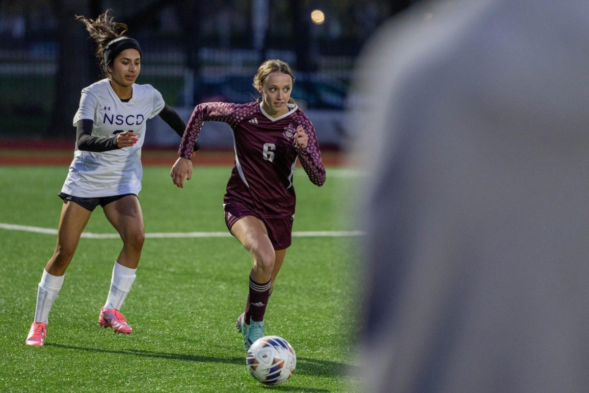 Senior Elsa Podszus scans the pitch while dribbling toward the opponent’s goal in a 4-2 victory over North Shore Country Day on April 10. 