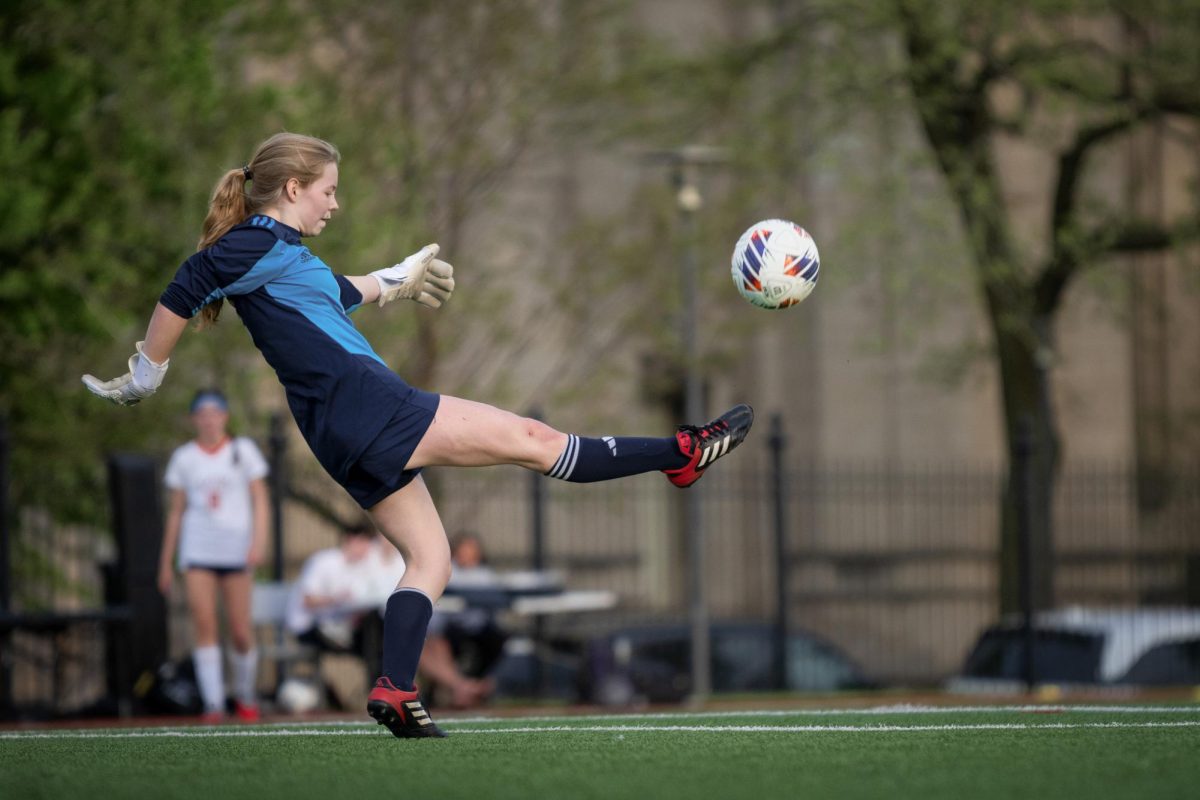 Sophomore Kate Stackert volleys the ball from the edge of the 18-yard box in a 1-8 loss to Latin School of Chicago on April 24. 