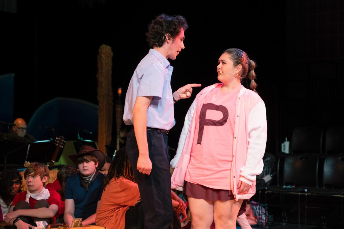 BIKINI BOTTOM BEEF. With an angrily pointed finger, junior Isaac Sutherland, playing Mr. Crabs, scolds ninth grader Vera Cyrenne, playing Pearl, Mr. Crabs’ daughter. “I loved the experience of getting to play an over-the-top teenage girl and having Isaac play my dad,” Vera said. “The cast was incredible, and I have so many good memories of getting to work with these amazing people.”
Photo by Simon Vaang 
