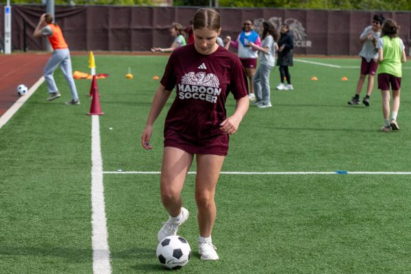 Ninth-grader Renn Henger, who is on the JV girls soccer team, practices her dribbling skills.