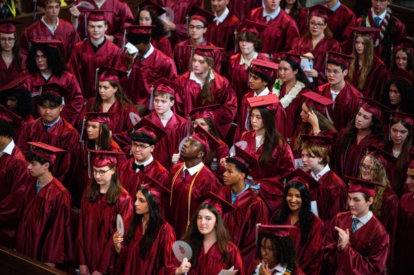 THE MAROON SEA. The Class of 2026 floods Rockefeller Chapel on June 11 for the 122nd University of Chicago Laboratory Schools Commencement. Students held fans. Rockefeller Chapel was overrun with heat during the ceremony.