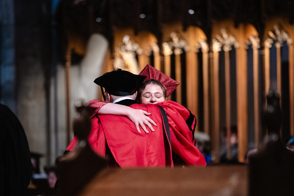 FAMILY TIES. Hannah Bueno de Mesquita embraces her father, Ethan Bueno de Mesquita, who served as the interim director of schools for the 2025-26 school year. Dr. Bueno de Mesquita shook the hand of every graduate but presented Hannah with her diploma.
