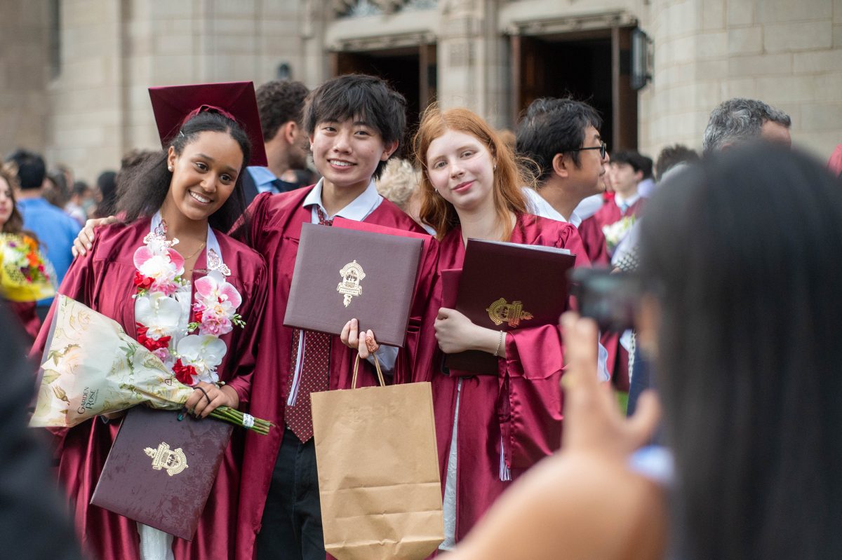 PERFECT PIC. Lia Teklu, Daniel Wu and Katherine Bean take a commemorative photo outside Rockefeller Chapel. 

