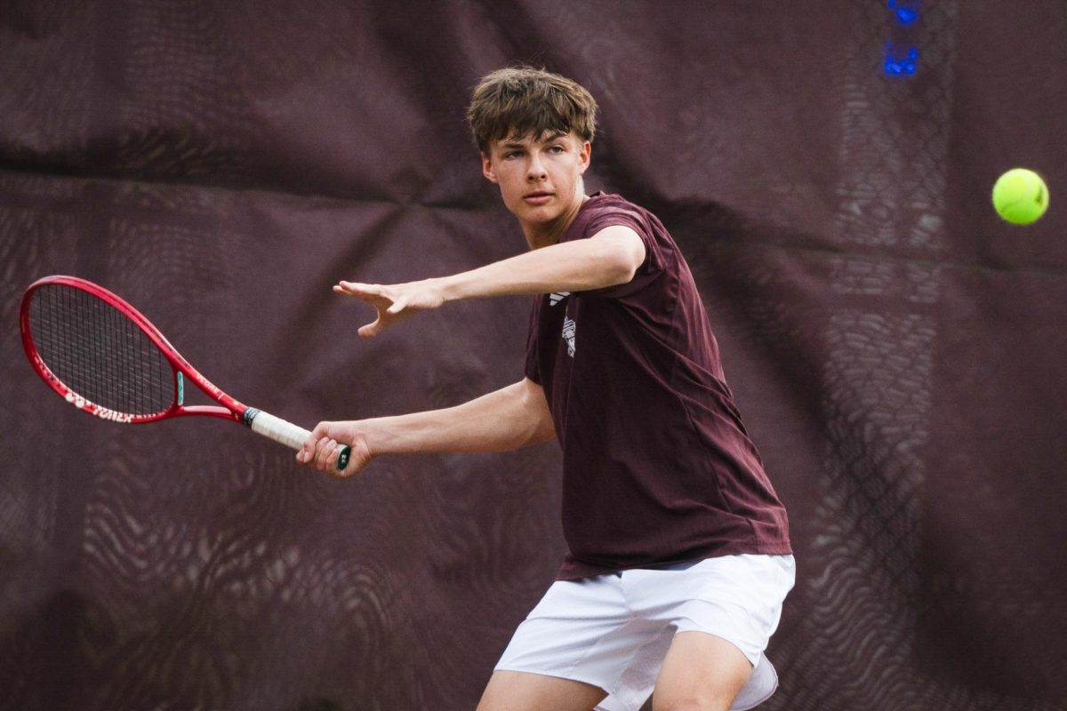Sophomore Nikolas Gulyayev connects on a forehand during a varsity tennis match against North Shore Country Day on April 24.