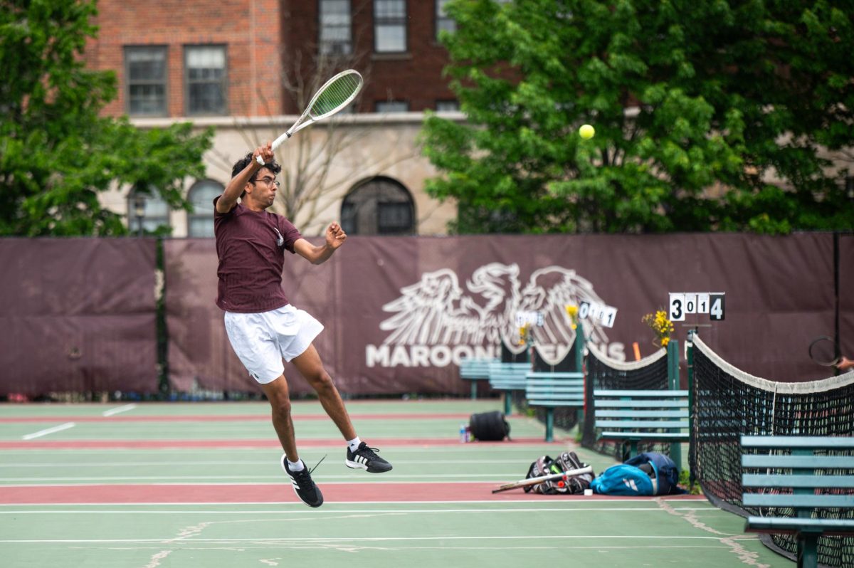 Junior Arjun Sawhney leaps into the air to strike the ball in a match against Whitney Young High School on May 19. Arjun was previously an individual state 1A finalist and on the 1A championship teams in 2024 and 2025. “I didn’t know about it at the time, but our two-doubles players had to play one-doubles, meaning they had to play the best doubles team at that school, to qualify for state,” Arjun said. “It was a massive learning curve for everybody.”