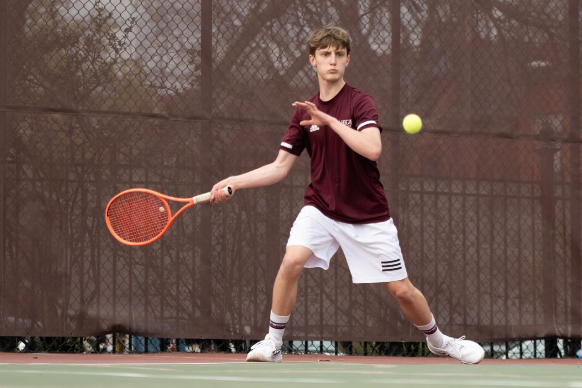 Sophomore Robert Giurcanu sets his feet to attack the ball in a junior varsity tennis match against Latin School of Chicago on April 9.