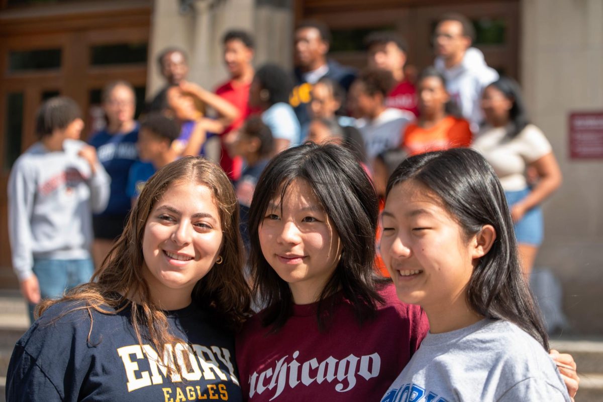 FINAL PHOTO. Dressed in college apparel, seniors Bayaan El-Bawab, Mulan Wu and Rachel Xiang take a photo together on Blaine steps after the breakfast. Mulan and Rachel’s May Project involved traveling to Taiwan and drawing various landmarks and sceneries during their visit. 